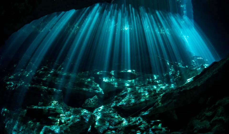 Sunbeams cutting through the fresh water of Cenote Ponderosa
