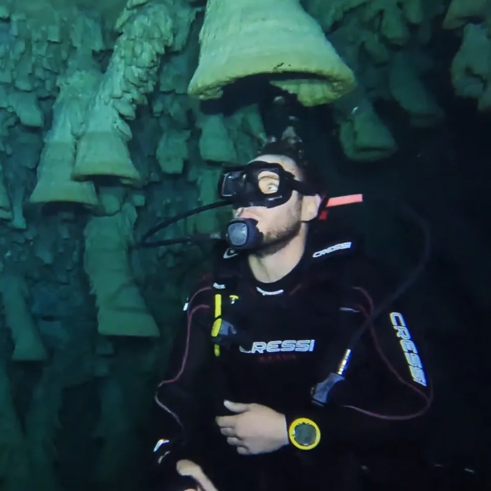 Diver looking up at the Hell's Bells formations in Cenote Zapote