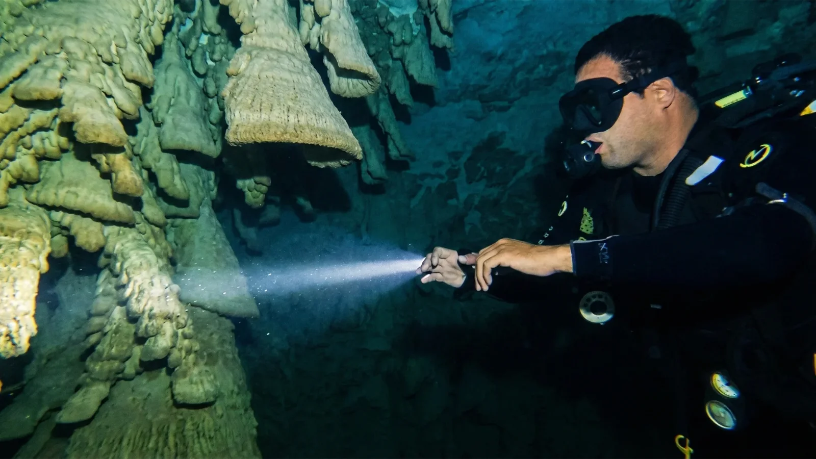 Diver lighting the Hell's Bells formations in Cenote Zapote