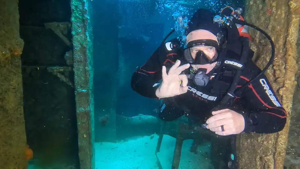 Diver inside the C-58 minesweeper wreck off Cancun